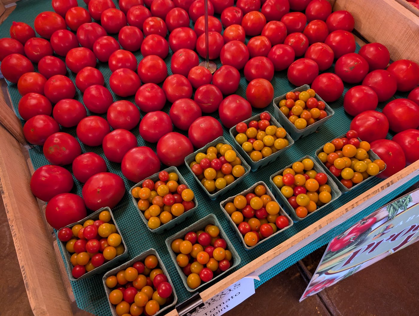 Ripe red tomatoes and pints of cherry tomatoes at the Abbey Farms stand