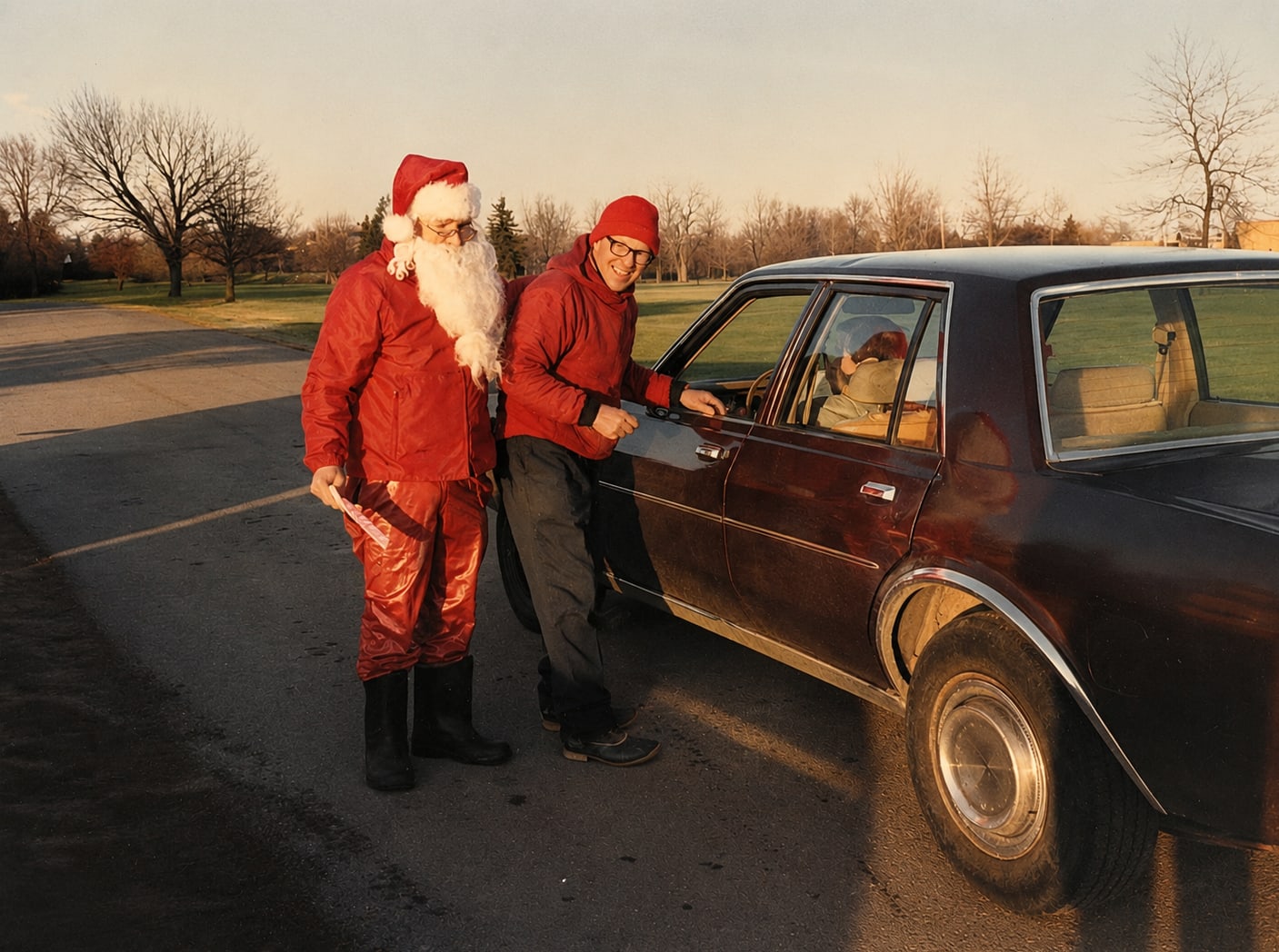 Santa greeting a visitor beside a car in the golden-hour fields at Abbey Farms